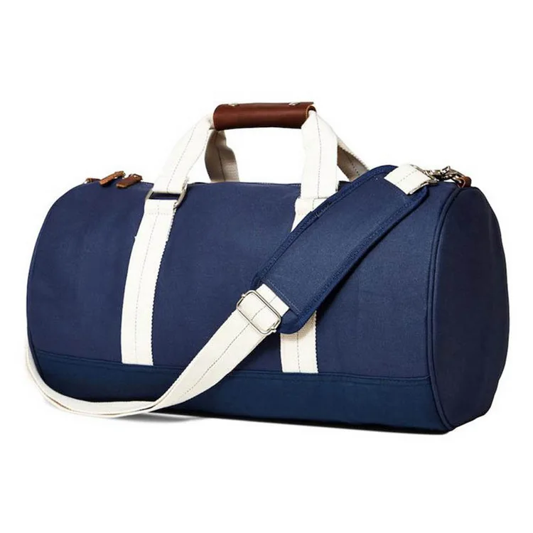 Navy canvas barrel duffel bag with cream webbing straps, a brown leather handle wrap and a shoulder strap