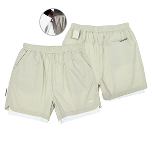 Two pairs of pale sage two-in-one training shorts with a built-in liner, elastic waist and zip rear pocket