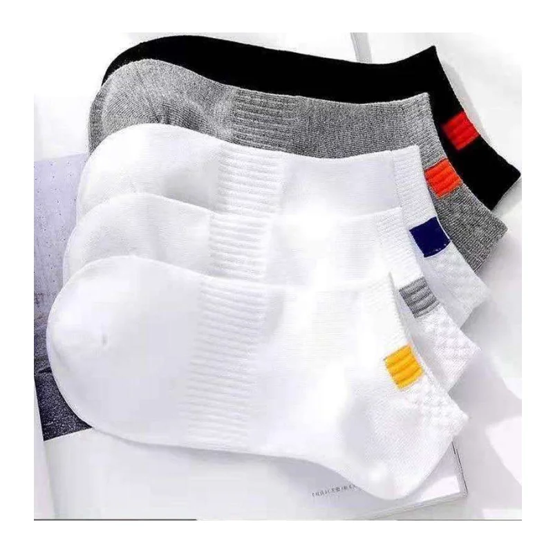 Stack of low-cut ankle socks in white, grey and black with small colour tabs and mesh instep panels