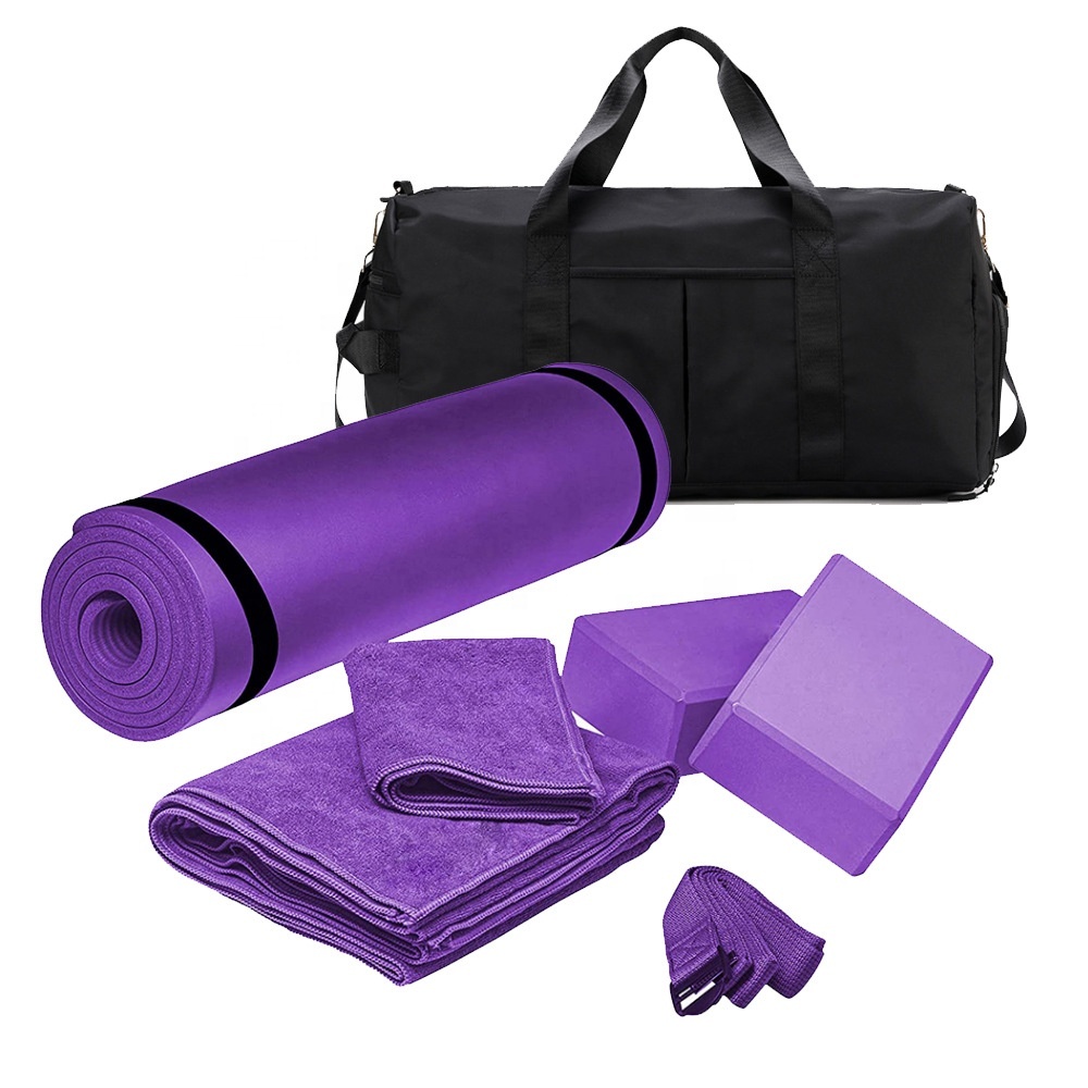 Purple yoga set with a rolled mat, two foam blocks, a strap, two microfibre towels and a black carry duffel